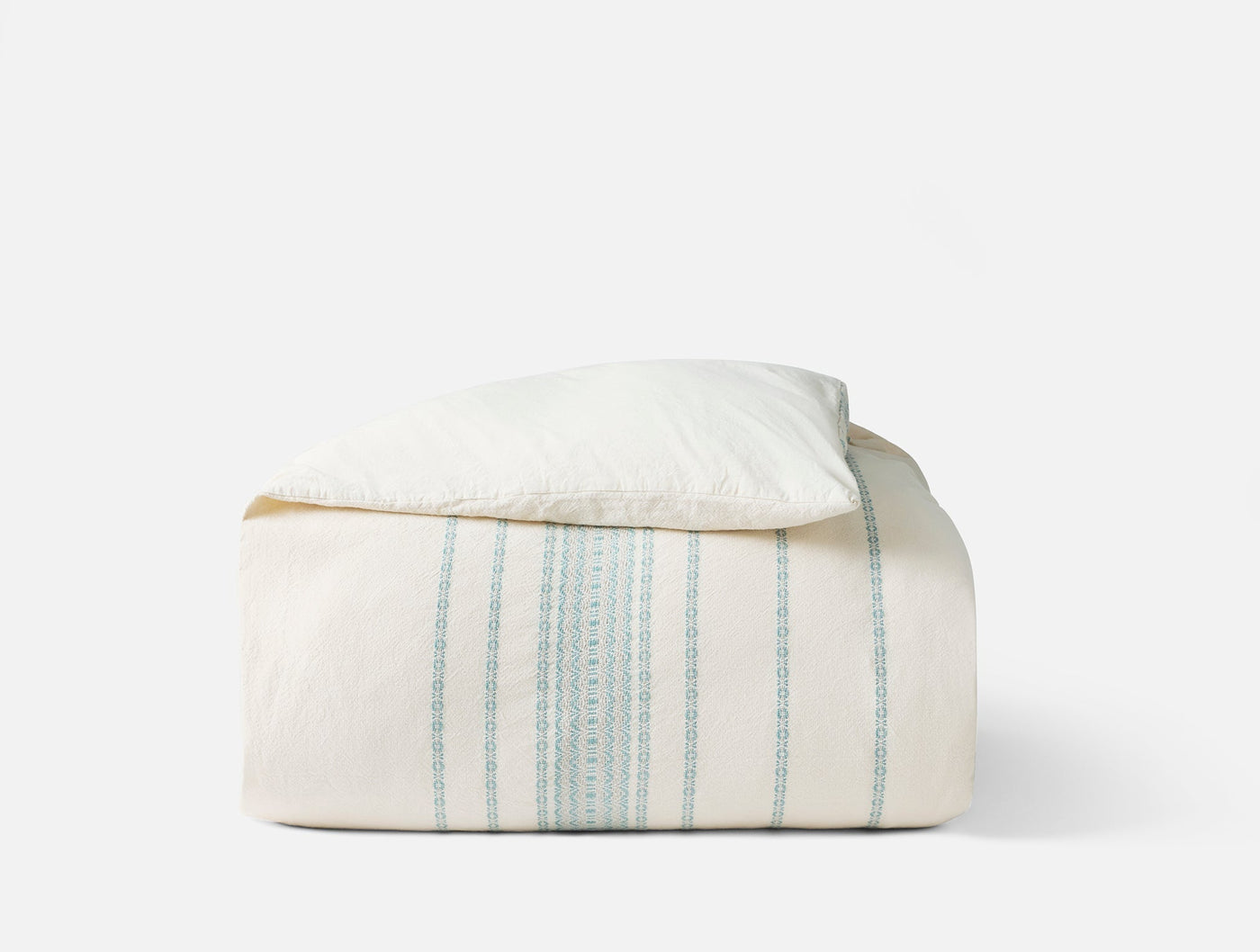 Coyuchi Rippled Stripe duvet cover folded, ivory with sage green vertical stripes.