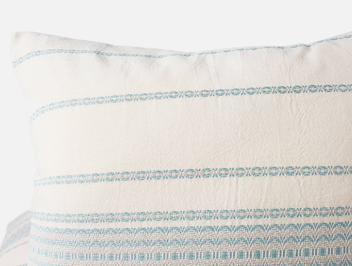 Close-up of aqua woven stripe detail on Coyuchi Rippled Stripe sham in ivory linen.