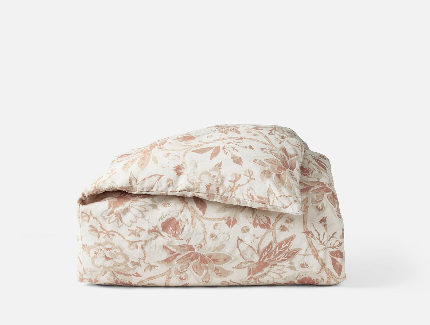 Coyuchi Sea Bloom Print duvet cover in blush floral pattern, neatly folded.