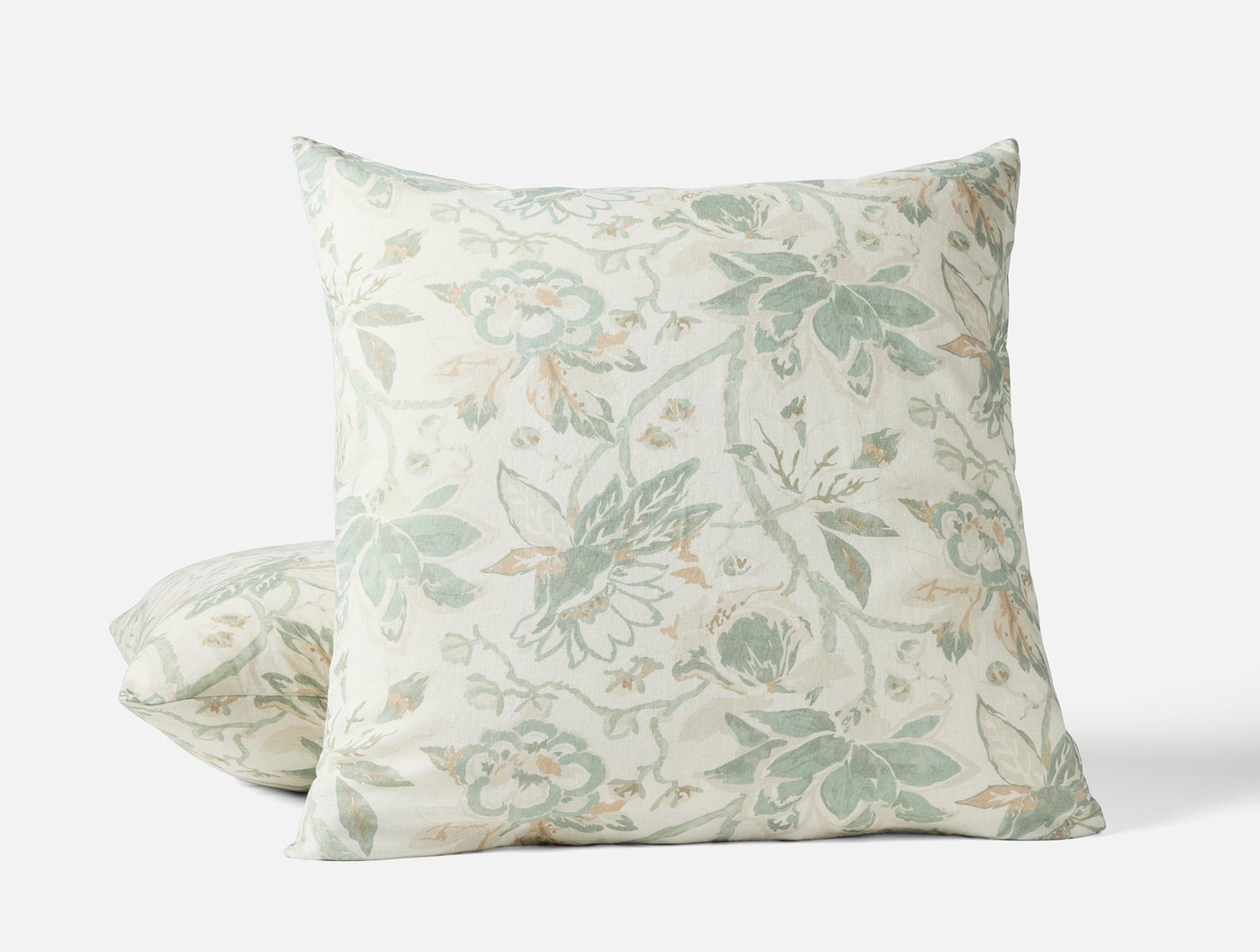 Sage and ivory jacobean floral print on two Coyuchi Sea Bloom pillow shams, stacked view.