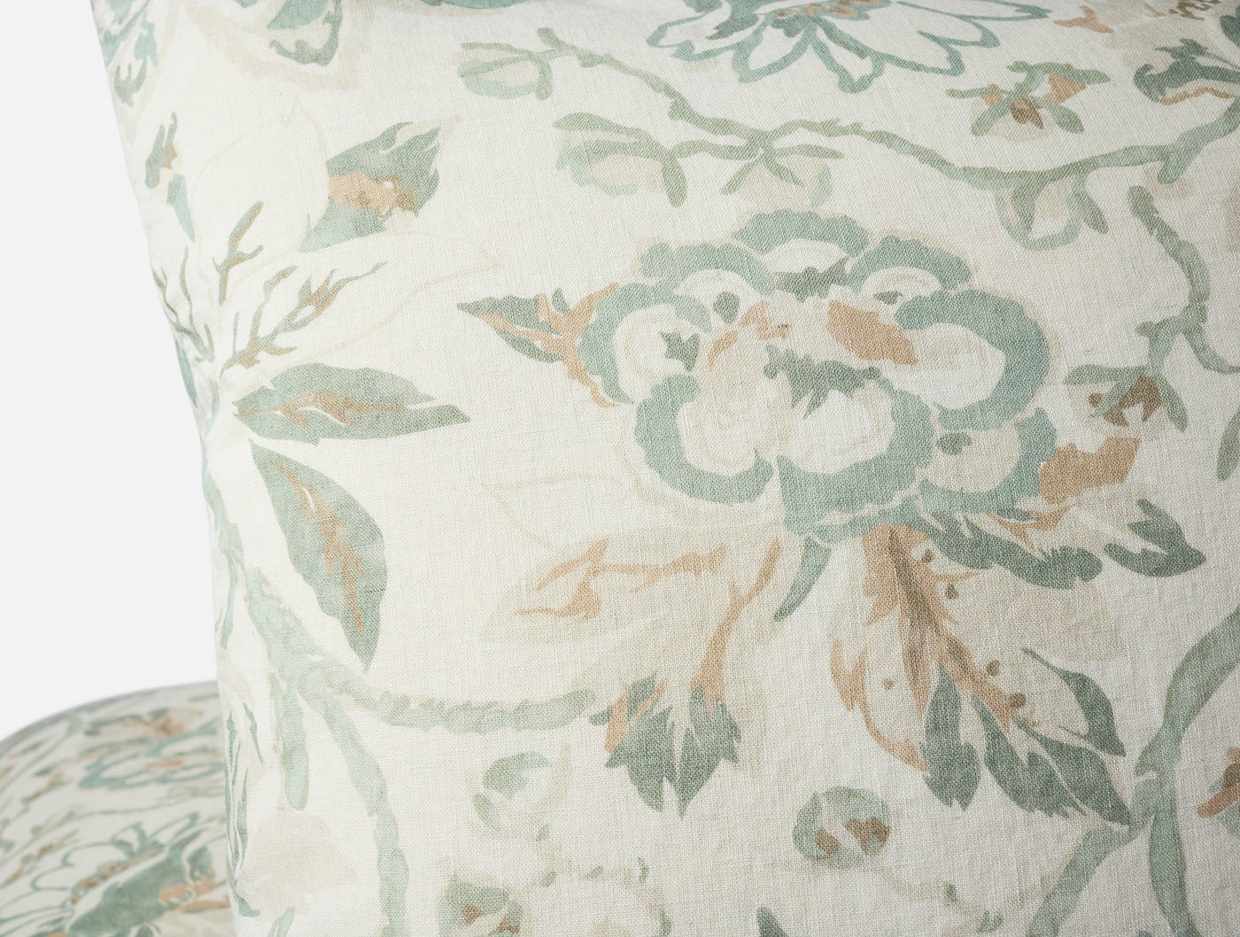 Close-up of Sea Bloom Print sham in sage and sand floral pattern on ivory linen.