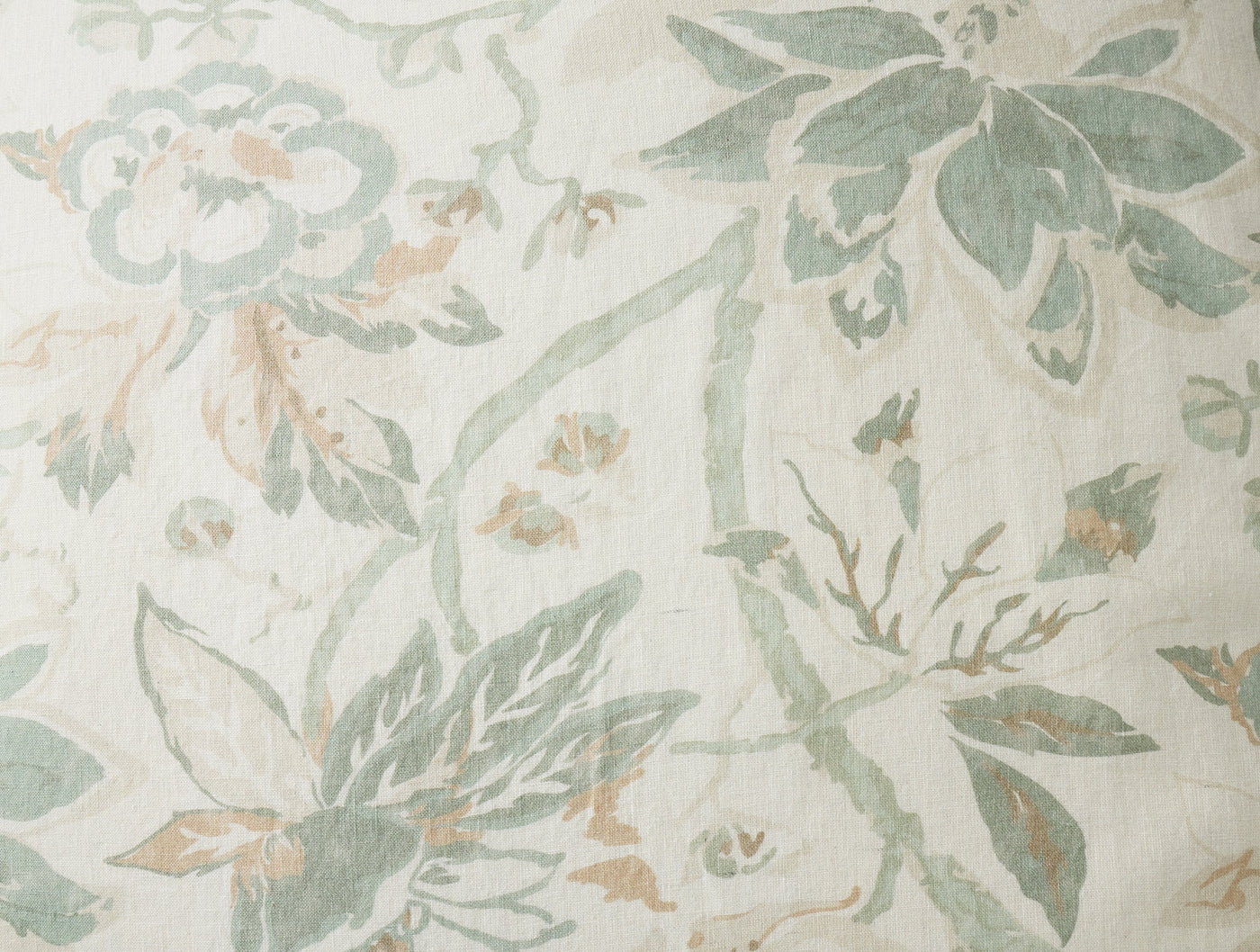 Close-up of Coyuchi Sea Bloom Print sham in sage and blush floral on ivory linen.