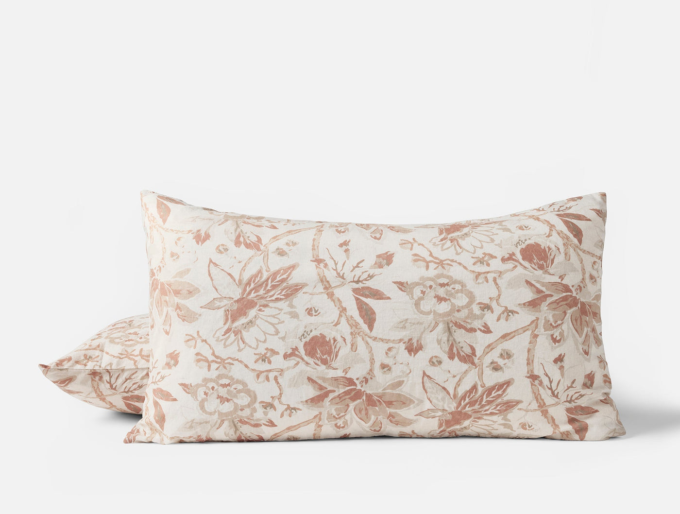 Close-up of Coyuchi Sea Bloom Print sham pair in terracotta floral pattern on ivory.