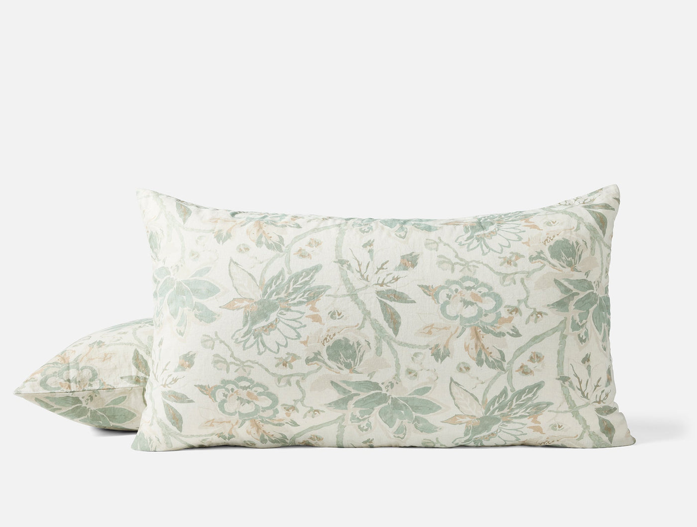 Pair of Coyuchi Sea Bloom shams with sage floral print on ivory linen, stacked view.
