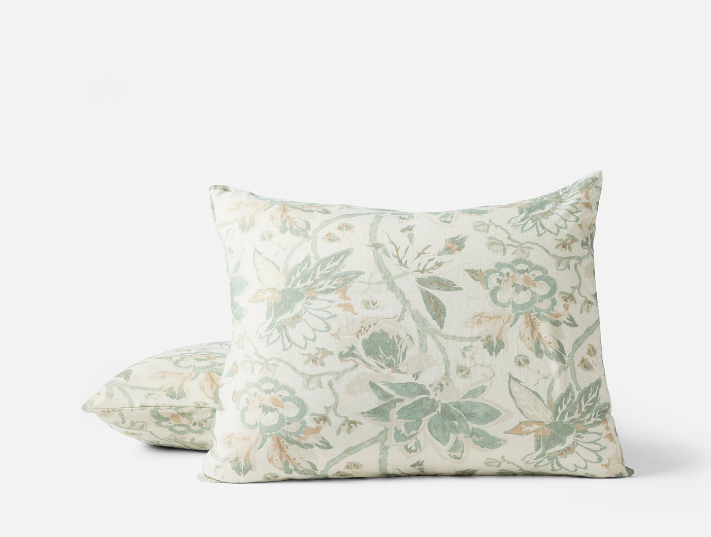Two Coyuchi Sea Bloom pillow shams stacked, sage green floral print on ivory linen.