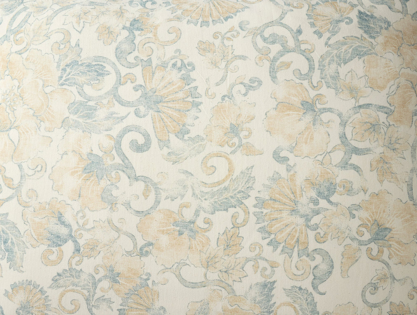 Close-up of Coyuchi Solana Print sham, ivory with soft blue and golden floral scroll pattern.