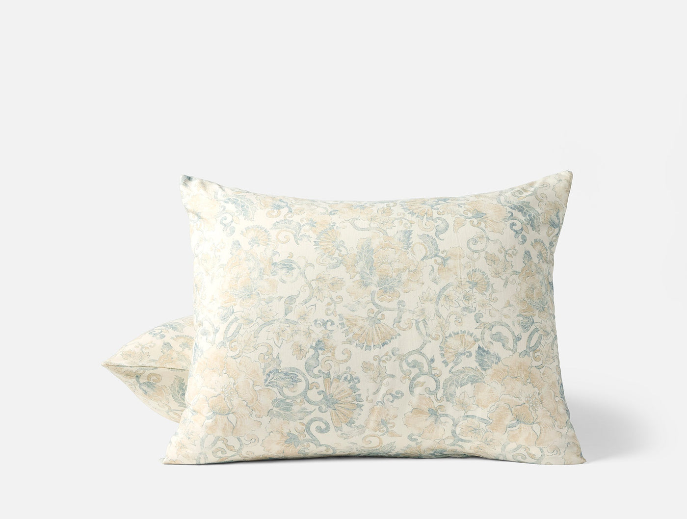 Pale blue and sand floral scroll print on ivory pillowshams, stacked pair view.