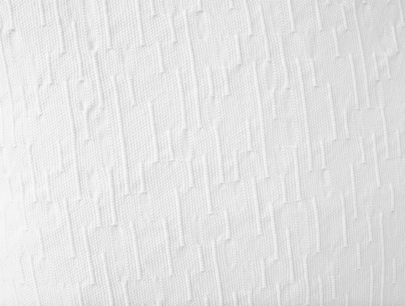 Close-up of white Toro Canyon pillow cover showing textured geometric woven pattern.