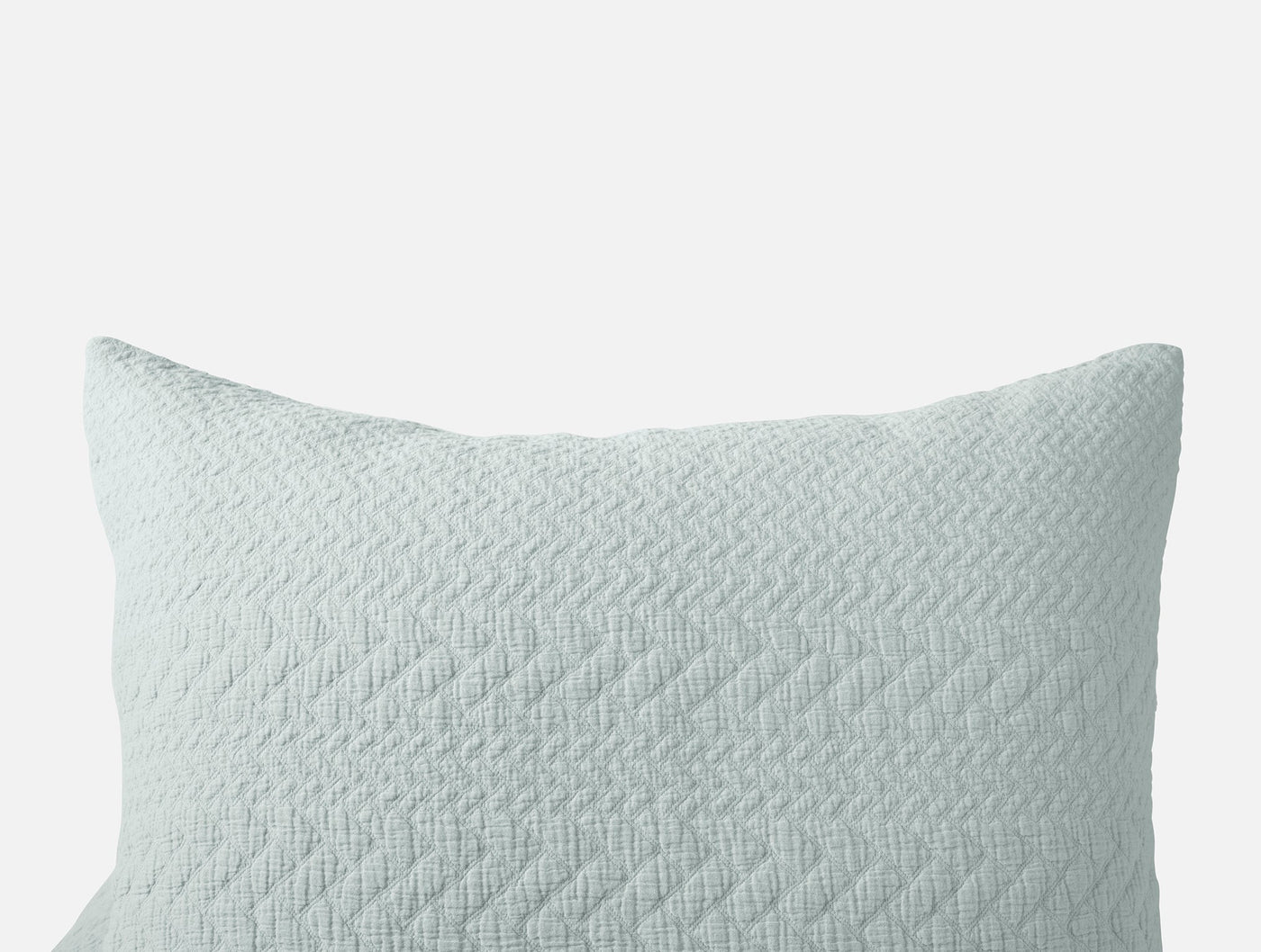 Close-up of Coyuchi Angeles Matelassé sham in seafoam with herringbone quilted texture.