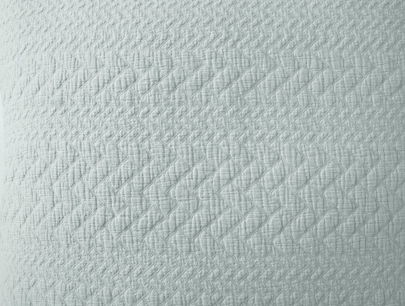 Close-up of Coyuchi Angeles Matelassé sham in pale aqua with diamond quilted weave texture.