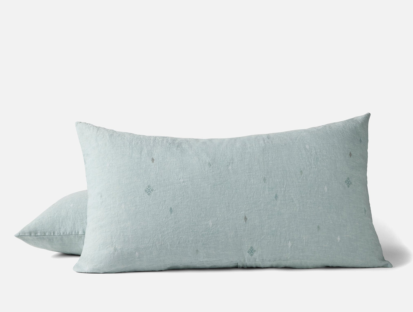 Close-up of two Cambria pillow shams in mist blue linen with subtle embroidered dot details.