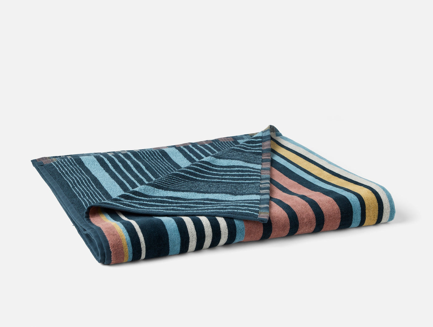 Coyuchi Dawn Stripe beach towel folded, showing multicolor stripe pattern in teal, gold, blush, and ivory.