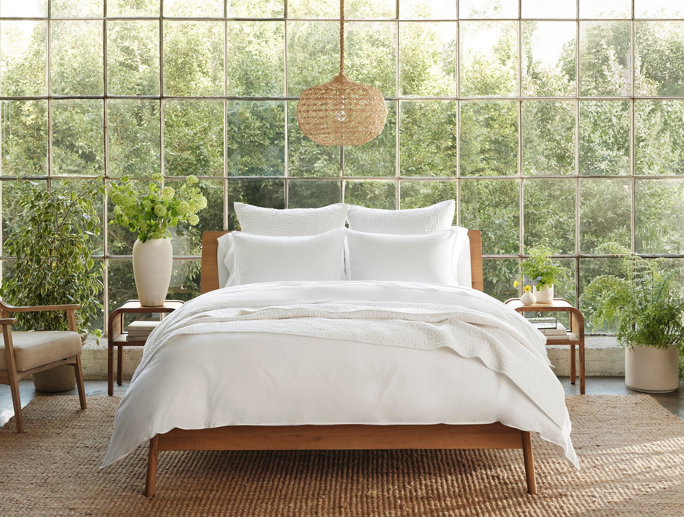 Coyuchi Crinkled Percale pillowcases styled on a made bed in a light-filled room.
