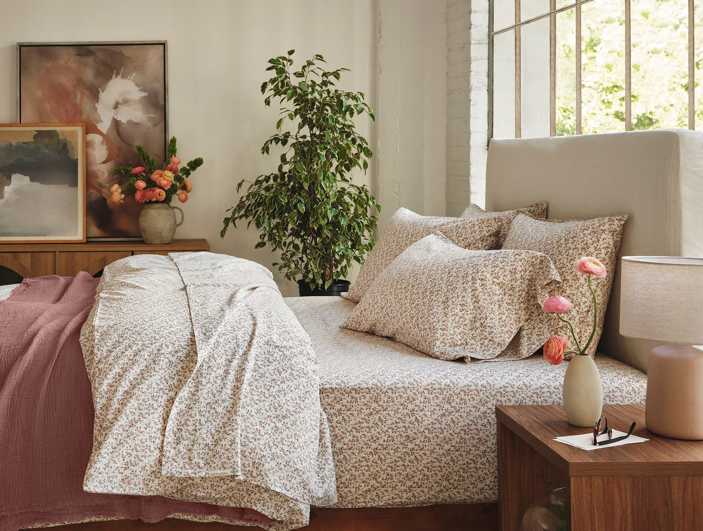 Coyuchi Print Percale sheet set styled on bed in warm-toned bedroom with botanical print.