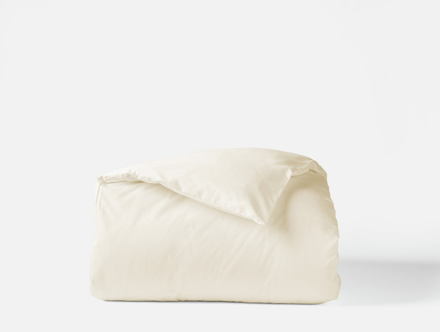 Folded ivory sateen duvet cover showing smooth lustrous finish against white background.