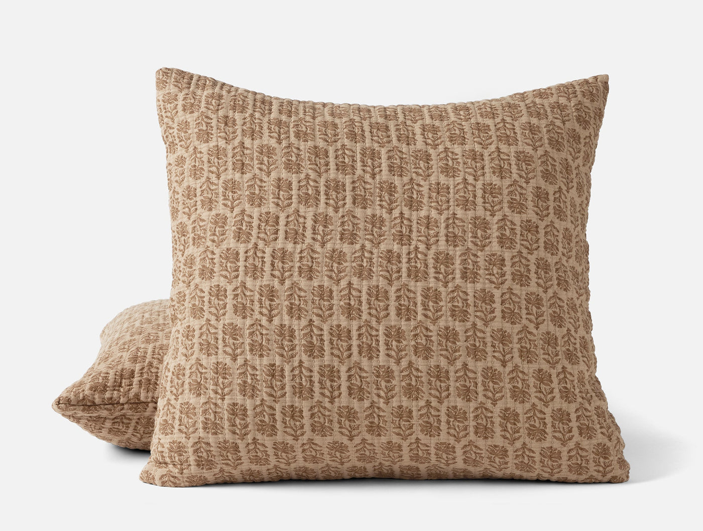 Coyuchi Mirada Matelassé pillow sham in camel with tone-on-tone botanical block print.