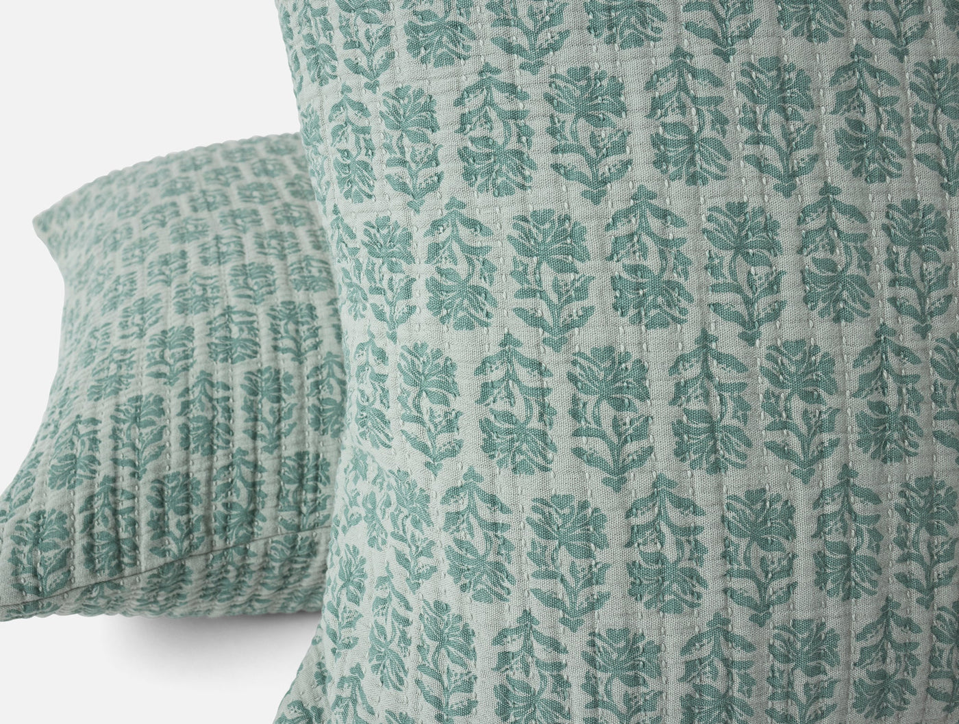 Close-up of teal block-print floral pattern on Coyuchi Mirada Matelasse sham fabric.
