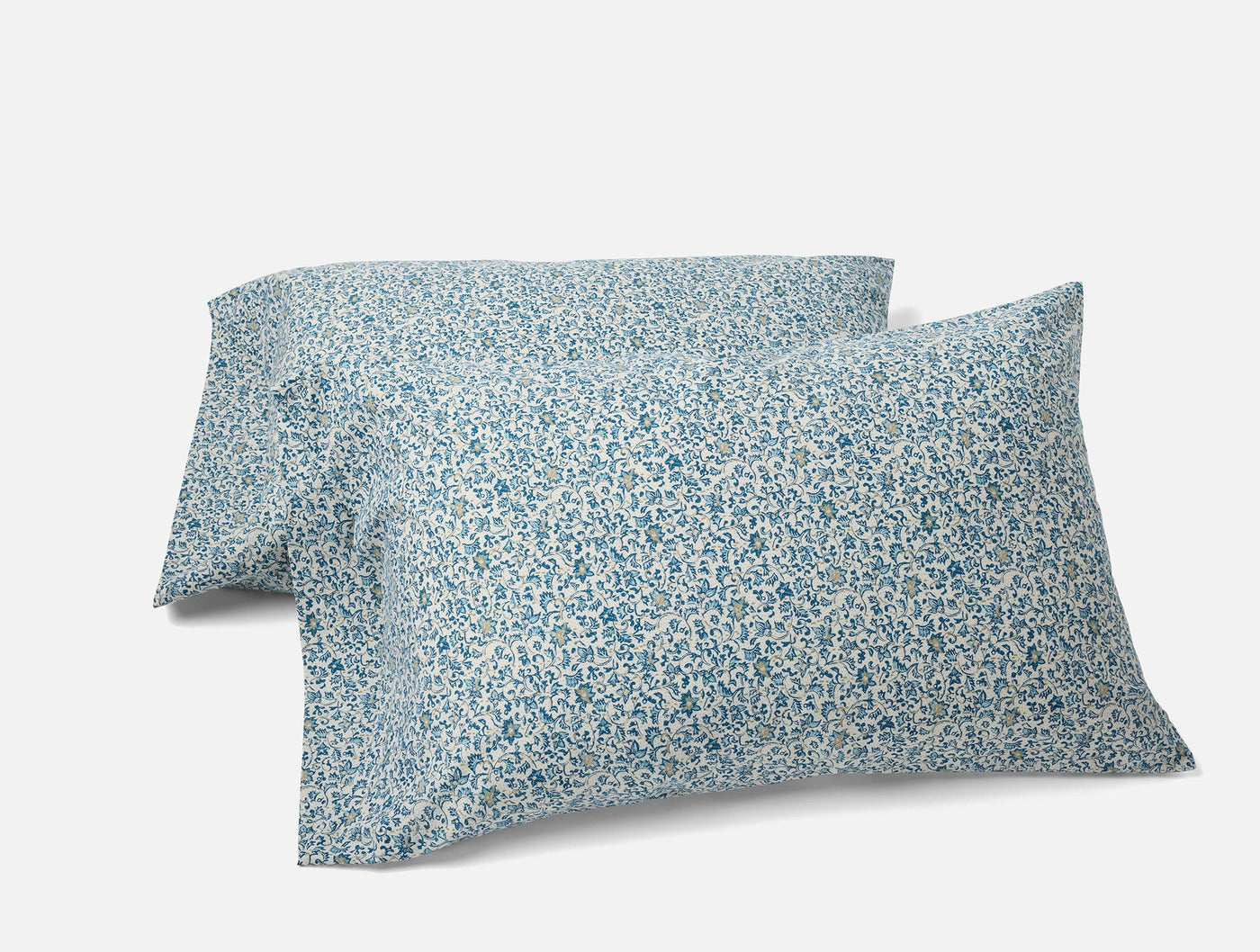 Pair of Coyuchi Print Percale pillowcases with blue floral pattern on white ground.