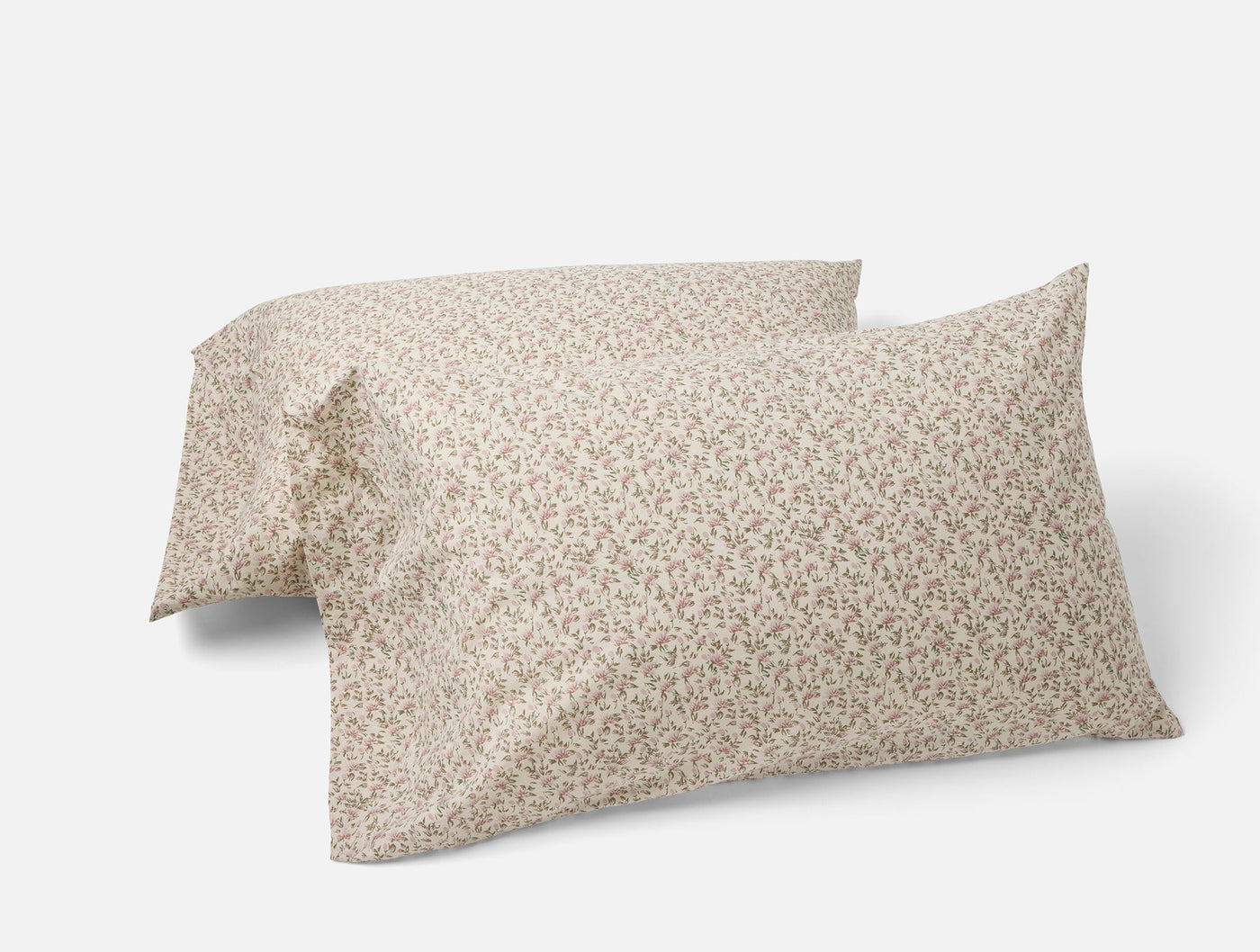 Two Coyuchi percale pillowcases with delicate ditsy floral print in warm taupe tones.