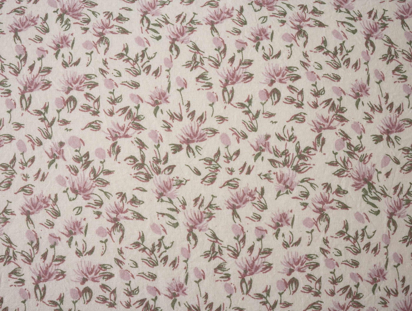 Close-up of Coyuchi Print Percale sham fabric with dusty rose floral and brown stem pattern.