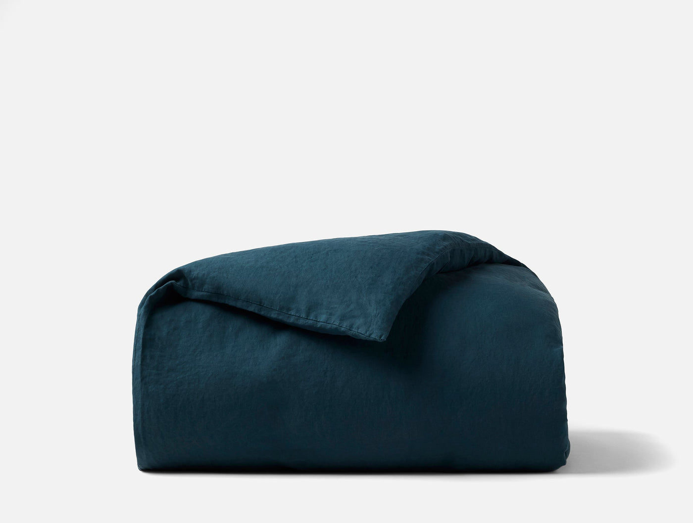 Coyuchi Relaxed Linen duvet cover in deep teal, folded to show texture.