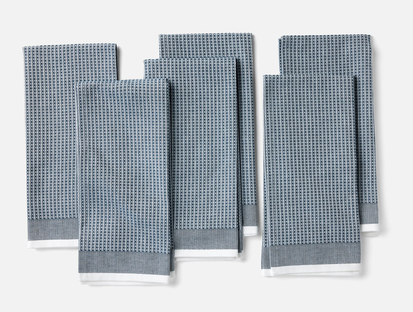 Coyuchi slate blue waffle-weave kitchen towels, set of six folded flat.