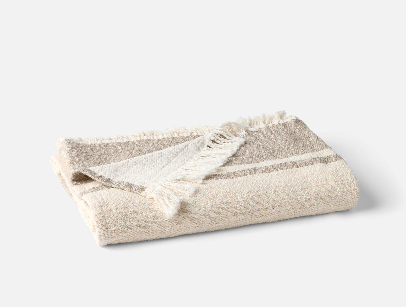 Coyuchi Pampas throw folded in ivory with taupe stripes and fringe trim.
