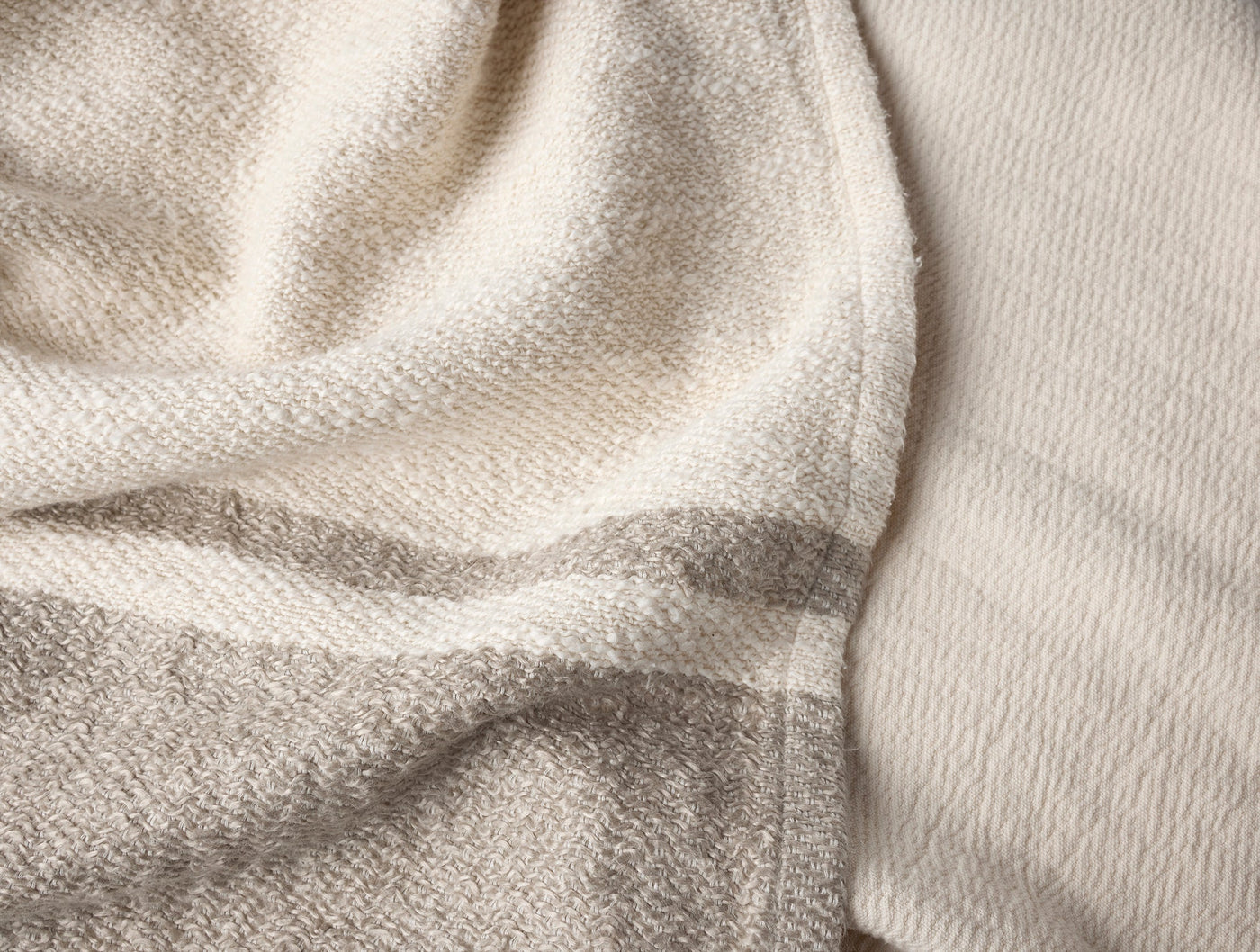 Close-up of Coyuchi Pampas throw showing ivory and natural woven stripe texture.