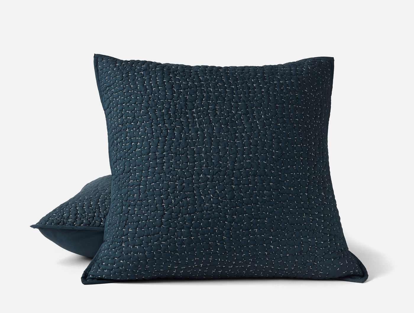 Close-up of Coyuchi Pebbled Handstitched sham in deep navy with textured kantha-style stitching.