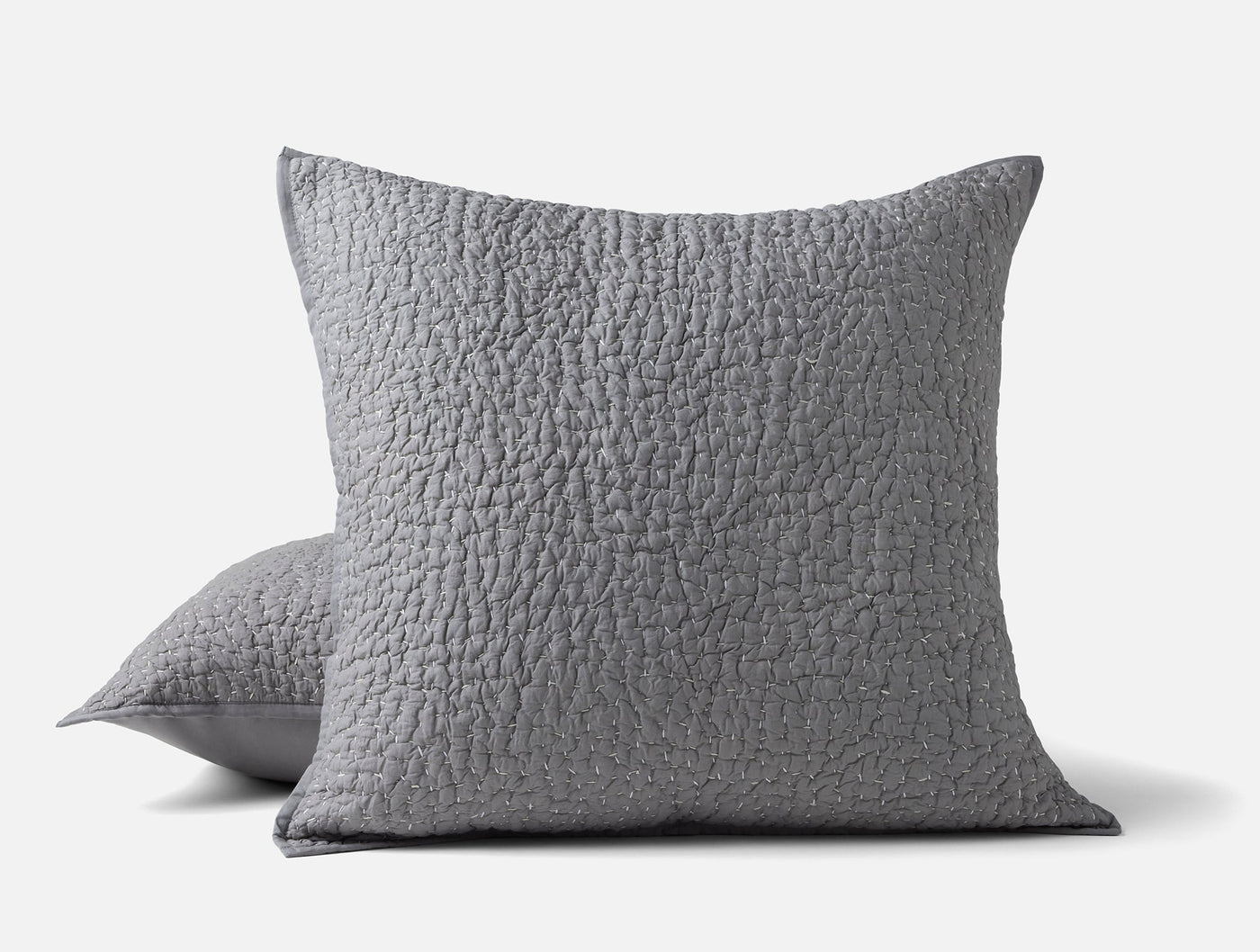 Two Coyuchi Pebbled Handstitched shams in slate grey with quilted texture, stacked.