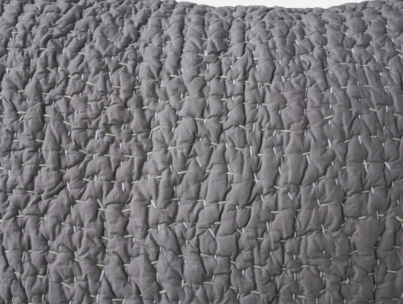 Close-up of Coyuchi Pebbled Handstitched sham in slate gray, showing quilted texture detail.