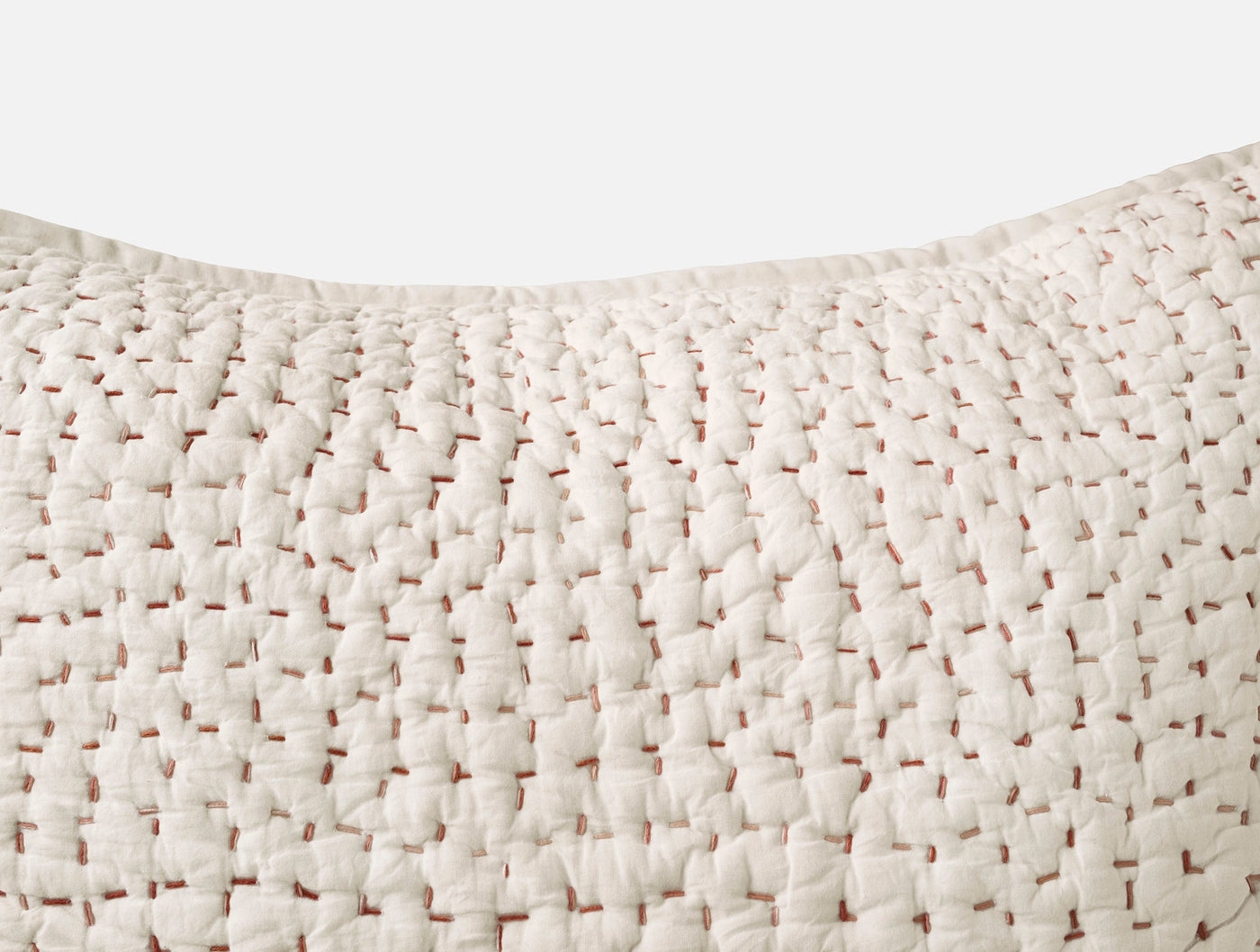 Close-up of ivory Coyuchi Pebbled Handstitched sham showing woven texture detail.