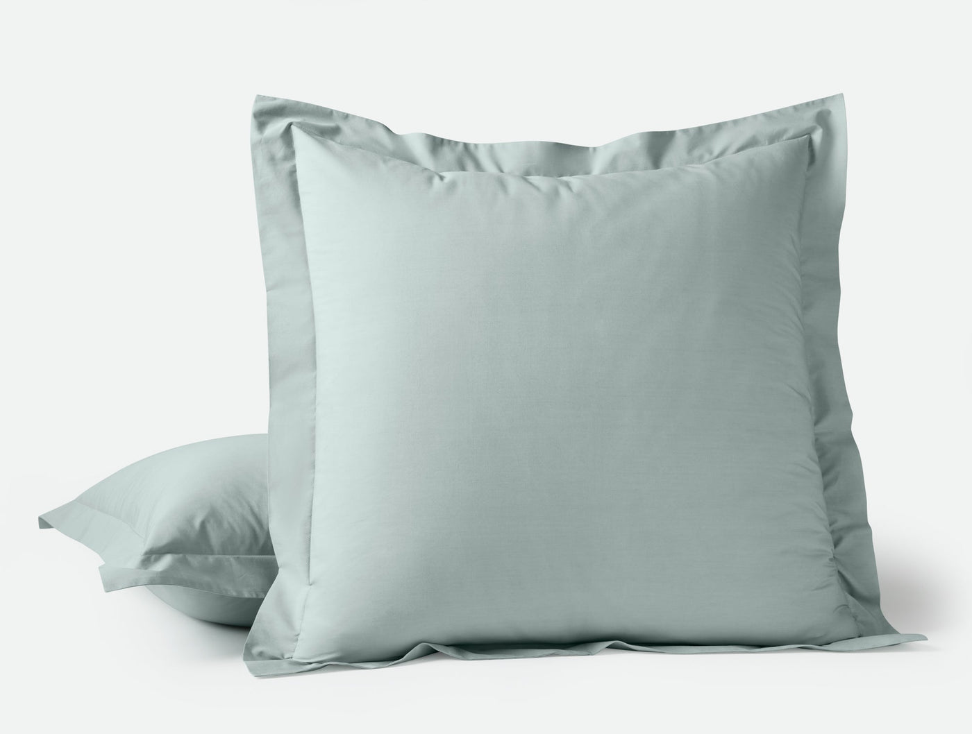 Sage green Coyuchi Refined Percale sham with flange border, stacked pair on white background.