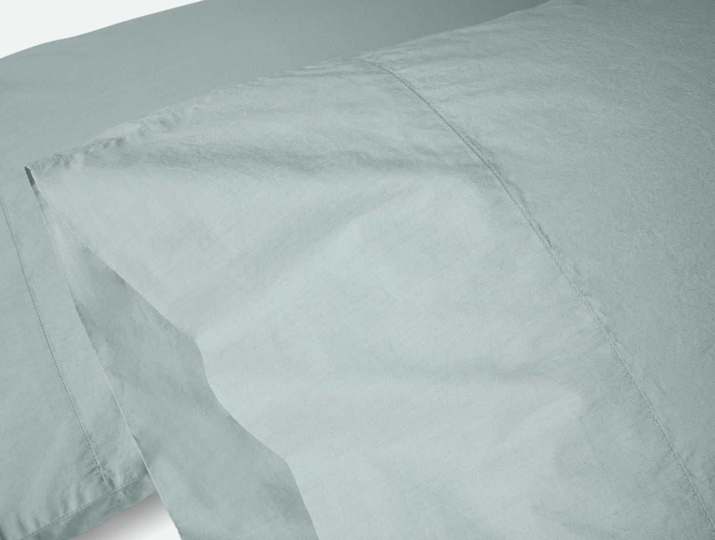 Close-up of Coyuchi Refined Percale pillowcase pair in mist, showing crisp percale weave.