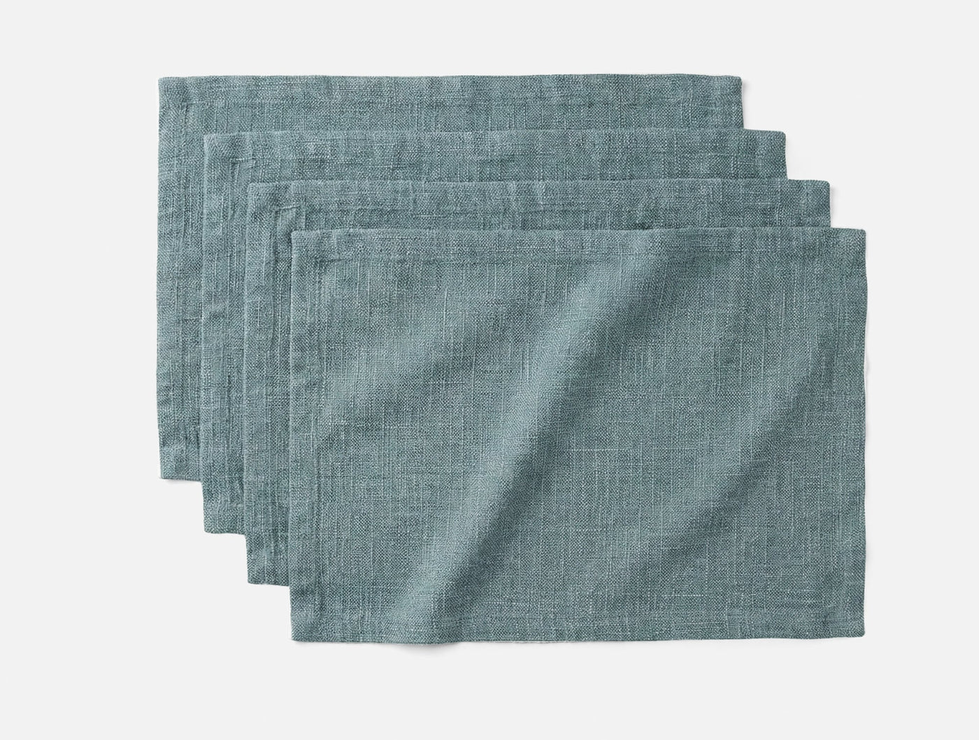 Set of four Coyuchi Toro Canyon placemats in slate blue linen, fanned arrangement.