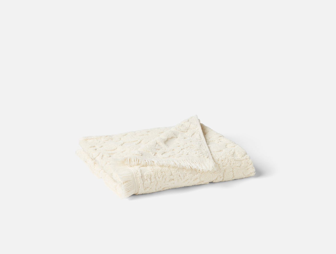 Folded ivory hand towel showing floral jacquard texture on light grey background.
