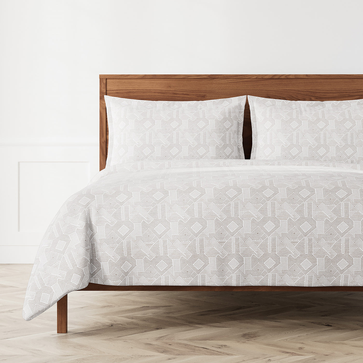 Ann Gish Sashiko duvet set in white with geometric jacquard pattern, styled on a wood bed.