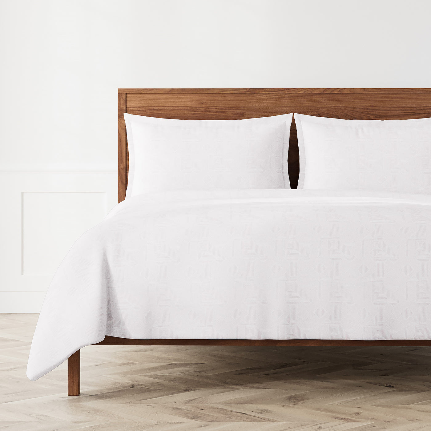 Ann Gish Sashiko duvet set in white, styled on a wood bed in a bright bedroom.