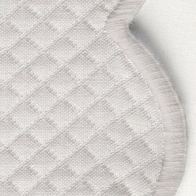 Close-up of the Savannah Gardens Napkin Set by Matouk: quilted light grey fabric with a diamond pattern and irregular scalloped edge, evoking elegant diamond pique table linens.