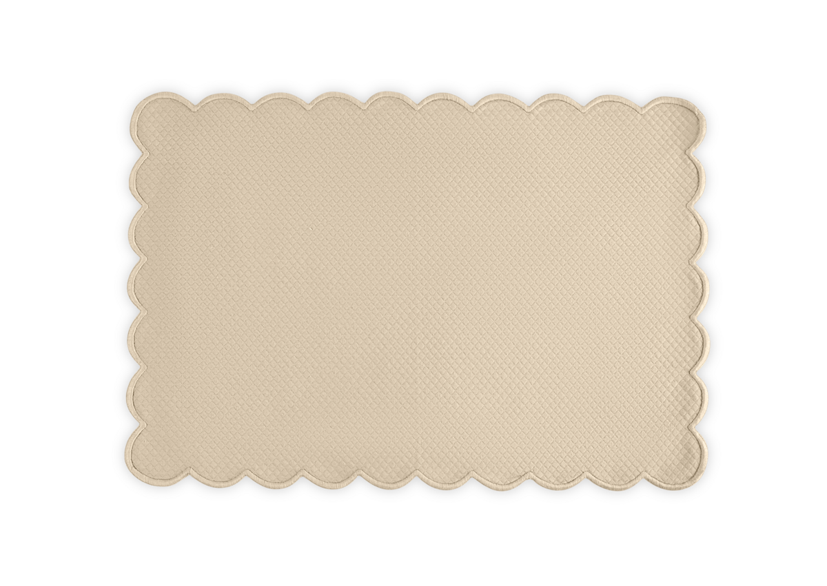 The Savannah Gardens Placemat Set by Matouk features a rectangular beige placemat with a textured diamond pique pattern and scalloped edges, adding elegance to your table setting.