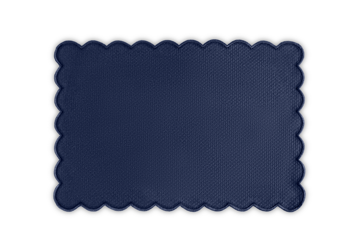 The Matouk Savannah Gardens Placemat Set features rectangular dark blue mats with a diamond pique texture and scalloped edges—an elegant addition to your table linens.