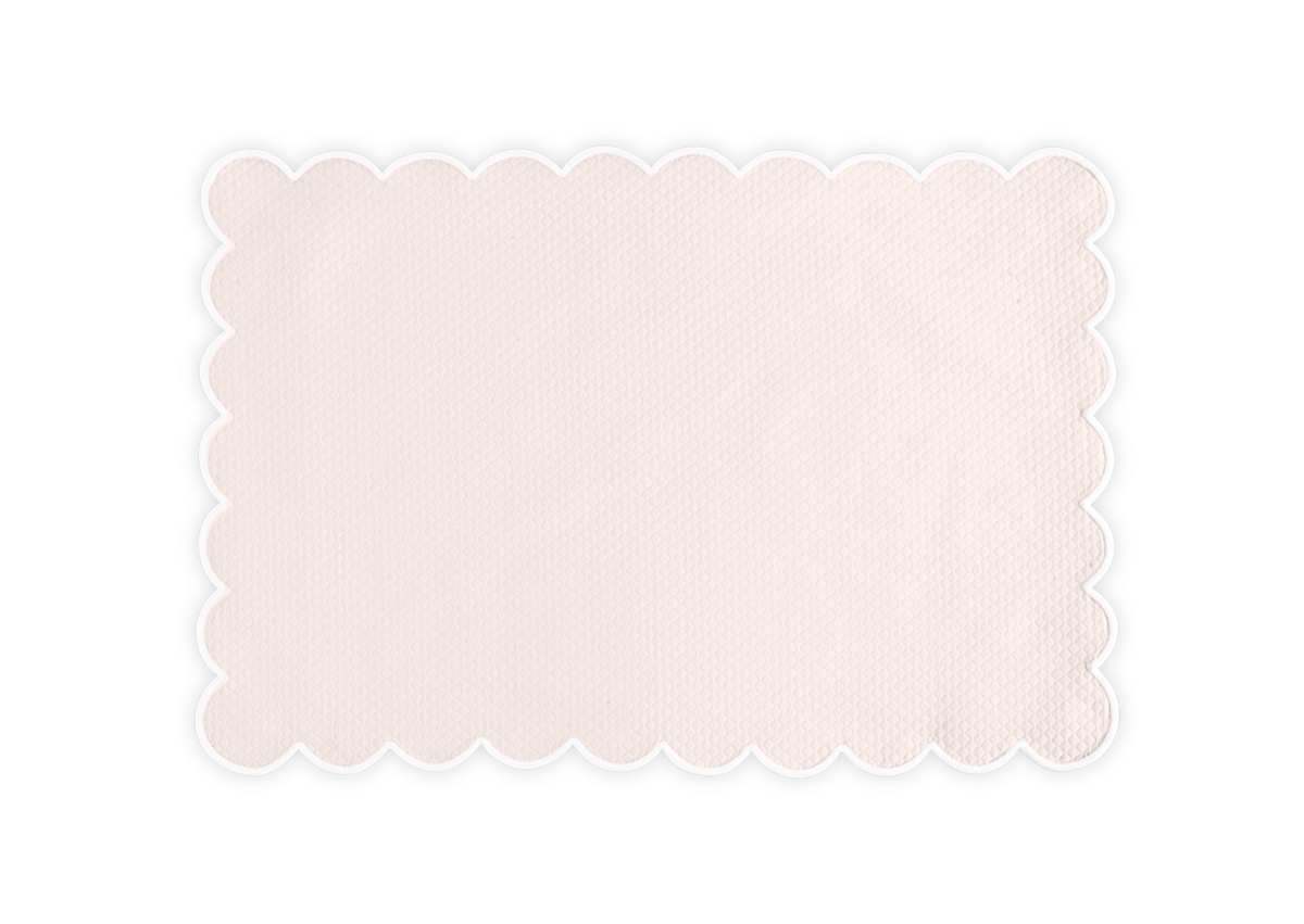 The Savannah Gardens placemat set by Matouk features rectangular beige mats made from signature diamond pique linens, with a textured surface and elegant scalloped edges, shown on a plain white background.