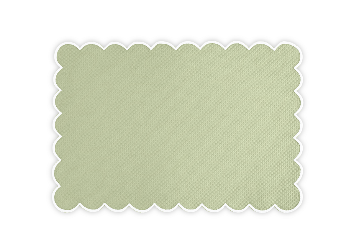 The Savannah Gardens Placemat Set by Matouk features a rectangular, light green diamond pique textured mat with scalloped edges, ideal for elegant table settings, shown on a white background.