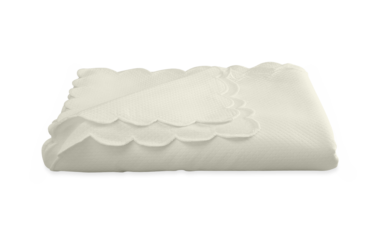 The Savannah Gardens Tablecloth by Matouk features a white diamond pique texture and scalloped edges, displayed on a plain white background.