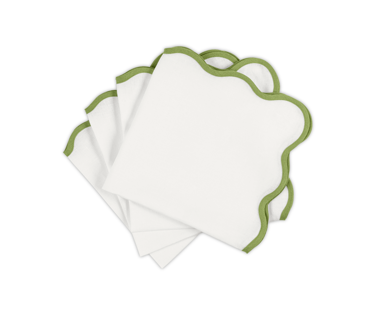 Matouk's Scallop Edge | Napkin Set, featuring elegant green stitching, is fanned out on a white background—ideal for elevating your tablescape or pairing with your favorite linen placemats.