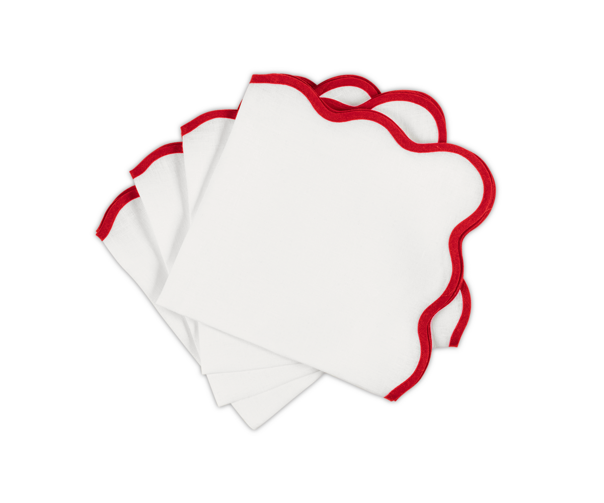 The Matouk Scallop Edge Napkin Set features four napkins with red-outlined scalloped edges, beautifully displayed on a white background—ideal for elevating your tablescape or pairing with your favorite linen placemats.