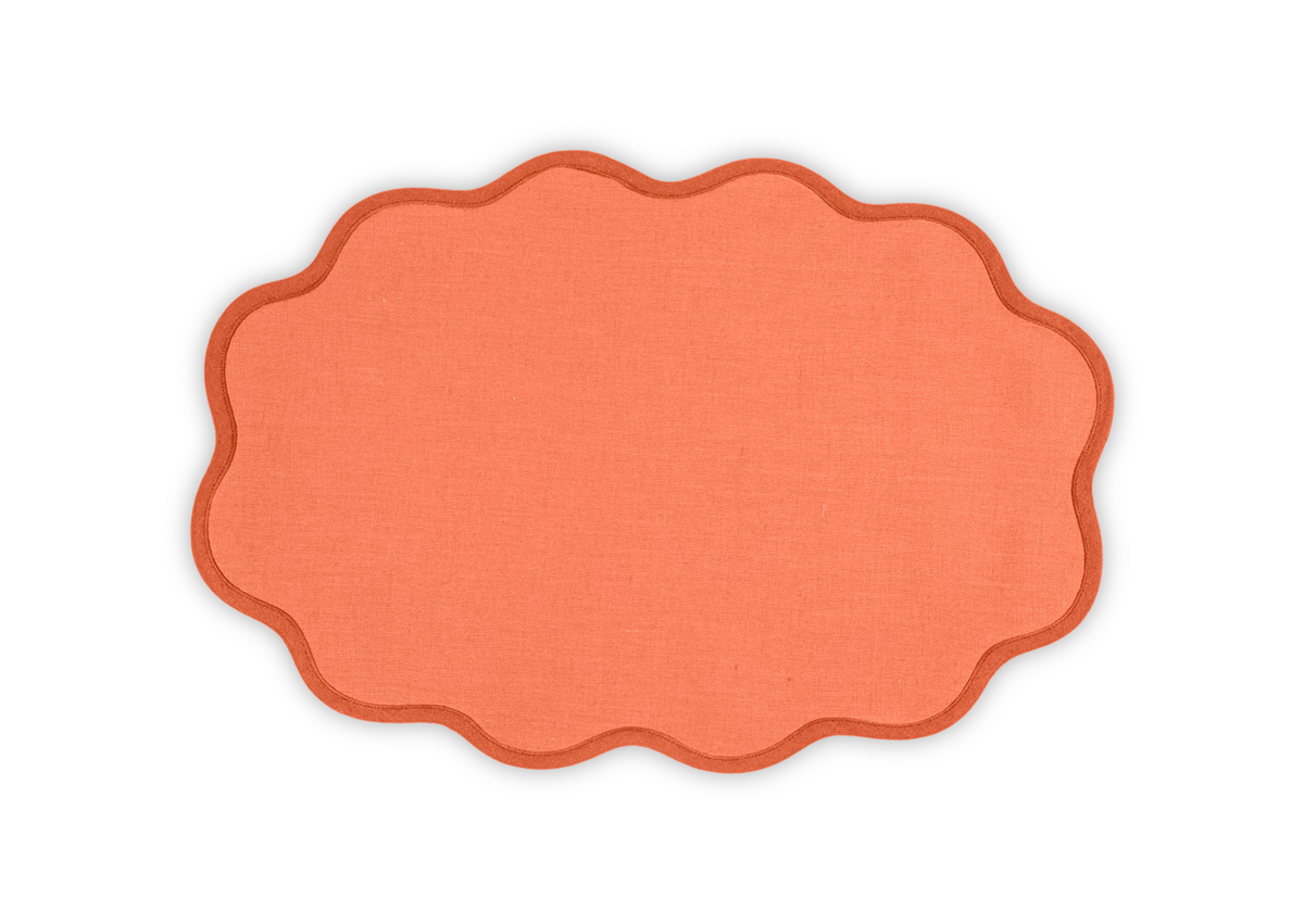 The Matouk Scallop Edge | Placemat Set features orange linen placemats with scalloped edges, shown against a white background—ideal for adding a unique touch to your tablescape.