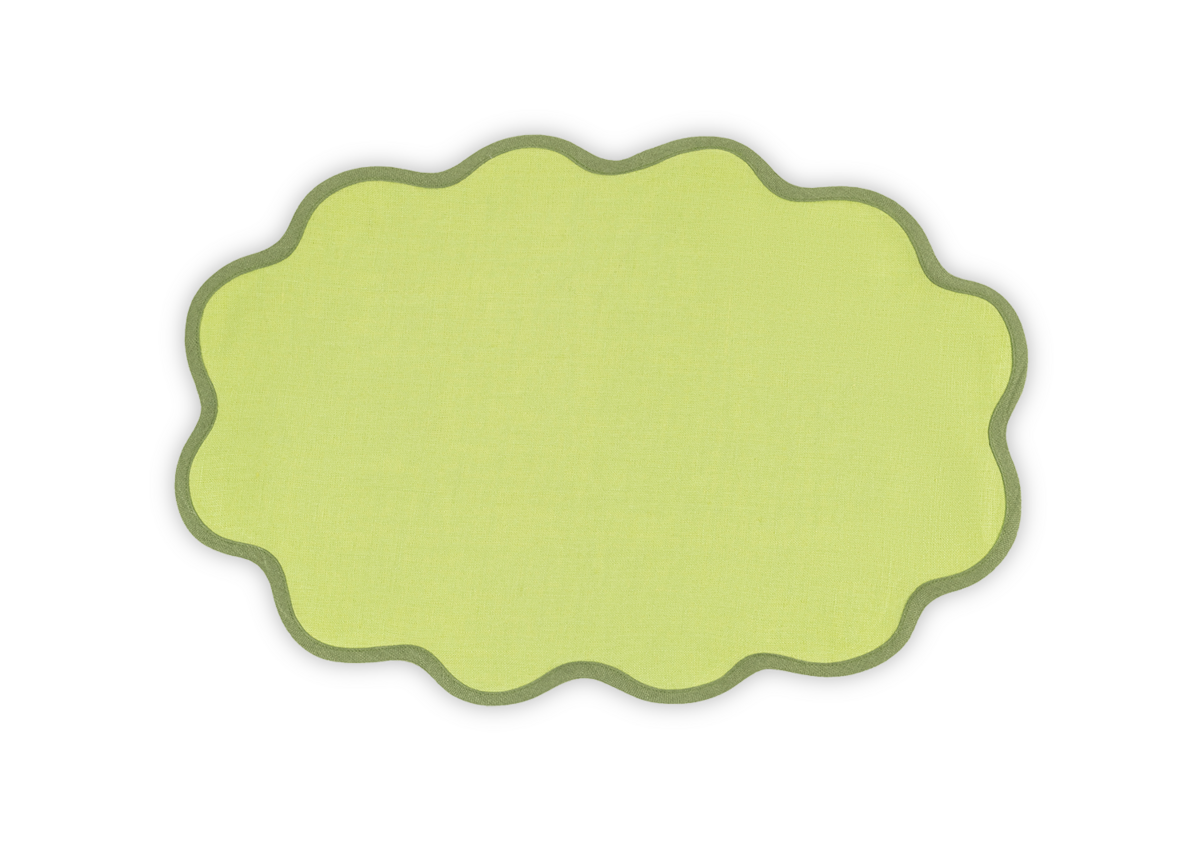 The Matouk Scallop Edge Placemat Set features oval, yellow linen placemats with green borders, ideal for a unique tablescape, shown on a plain white background.
