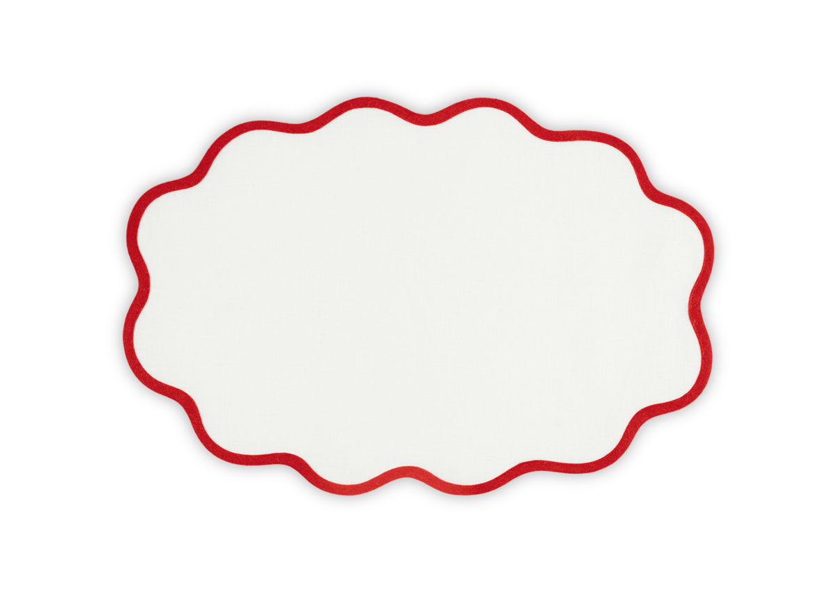 A white oval with a red scalloped edge, inspired by the Scallop Edge | Placemat Set from Matouk, adds a unique tablescape touch against a plain background.