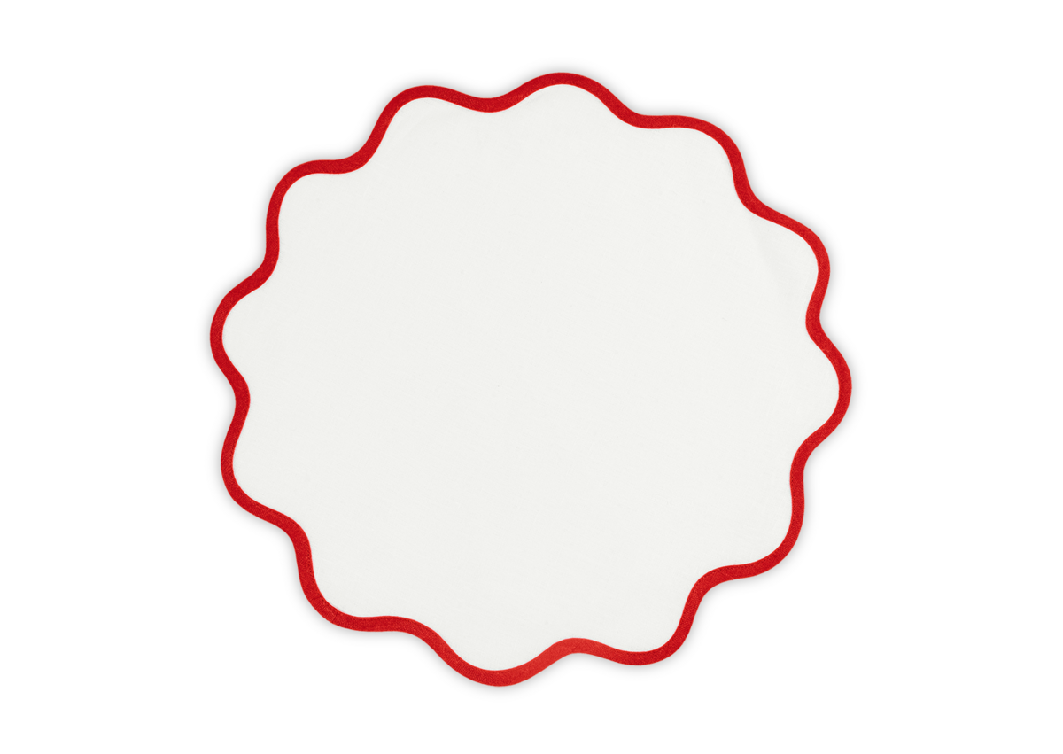The Matouk Scallop Edge Placemat Set features round white linen placemats with red wavy scallop edges, perfect for creating a unique tablescape, shown on a white background.